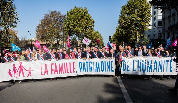 Image of Manif pour Tous protestors yielding a banner that reads 